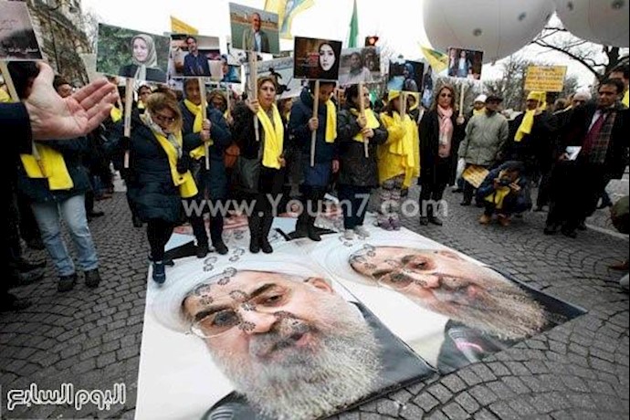 بالصور..تظاهرات حاشدة بباريس ضد زيارة روحانی وتنديدا بتنفيذ"الإعدام" بإيران