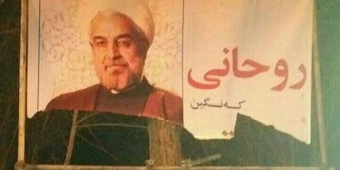 الشباب من أهالي يزد يمزقون اللافتة الکبيرة للملا روحاني